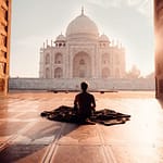 person sitting in front of the taj mahal