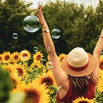 woman surrounded by sunflowers