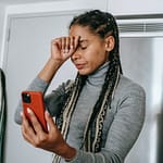 sad young ethnic lady arguing during video call